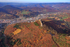 City overview behind the Trifels in the autumn forest from the south in Annweiler am Trifels in the state Rhineland-Palatinate, Germany