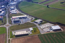 Oblique view of Industrial area in the Speyer Valley with ITK Engineering GmbH, Resinnovation GmbH, TRANSAC International Shipping Company Ltd., and Markthalle 5 in Rülzheim in the state Rhineland-Palatinate, Germany