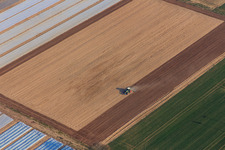 Tractor harrowing a field in Freisbach in the state Rhineland-Palatinate, Germany