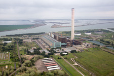 Aerial view of Tanks, power plants and exhaust towers of the oil-fired power plant at the mouth of the Po in Case Ocaro in the state Veneto, Italy
