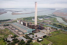 Aerial view of Tanks, power plants and exhaust towers of the oil-fired power plant at the mouth of the Po in the district Centrale Enel in Porto Tolle in the state Rovigo, Italy