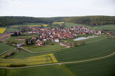 Village - view on the edge of agricultural fields and farmland in Rauhenebrach in the state Bavaria, Germany