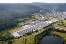 Aerial view of Building and production halls on the premises of Rauch Moebelwerke GmbH in Freudenberg in the state Baden-Wurttemberg, Germany