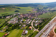 Aerial view of Village - view behind motorway A3 on the edge of agricultural fields and farmland in the district Dertingen in Wertheim in the state Baden-Wurttemberg