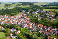 Aerial view of Village - view on the edge of agricultural fields and farmland in Wuestenzell in the state Bavaria, Germany