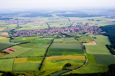 Village - view on the edge of agricultural fields and farmland in Waldbuettelbrunn in the state Bavaria, Germany
