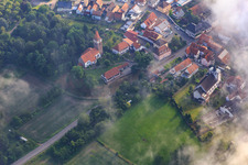 Aerial view of Protestant and Catholic Church under clouds in Minfeld in the state Rhineland-Palatinate, Germany