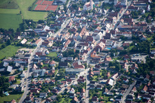 Town View of the streets and houses below clouds of the residential areas in Geiselhoering in the state Bavaria from above