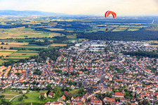 Paraglider over the city from the northeast in Lorsch in the state Hesse, Germany
