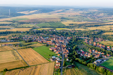Village - view on the edge of agricultural fields and farmland in Steinbach am Donnersberg in the state Rhineland-Palatinate, Germany
