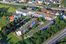 Terraced housing estate with colorful facades in Am Bahnhof in the district Sandwiese in Alsbach-Hähnlein in the state Hesse, Germany