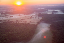 Sunrise in morning mist over the countryside Bruchbach-Otterbachniederung in Kandel in the state Rhineland-Palatinate