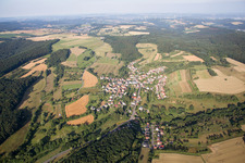 Aerial view of Village - view on the edge of agricultural fields and farmland in Frohnhofen in the state Rhineland-Palatinate, Germany