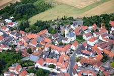 Aerial view of Village - view on the edge of agricultural fields and farmland in Kerzenheim in the state Rhineland-Palatinate, Germany