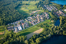 Village on the lake bank areas of lake for gravel mining near the river Rhine in the district Grauelsbaum in Lichtenau in the state Baden-Wurttemberg, Germany