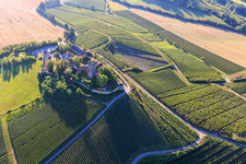 Ravensburg Castle (Sulzfeld) in the morning on a hill with vineyards in Sulzfeld in the state Baden-Wuerttemberg, Germany viewn from the air