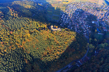 Castle ruins of Landeck Castle in the autumn forest at evening light in Klingenmünster in the state Rhineland-Palatinate, Germany from above
