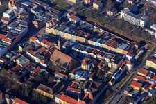 Town houses on the town square and parish church of St. Simon and Judas in Pfarrkirchen in the state Bavaria, Germany