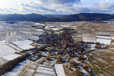 Village view in winter with snow from the east in Göcklingen in the state Rhineland-Palatinate, Germany