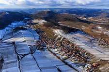 View of the winegrowing village in winter with snow-covered vineyards from the east in Ranschbach in the state Rhineland-Palatinate, Germany
