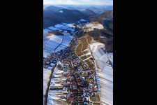 Aerial photograpy of View of the winegrowing village in winter with snow-covered vineyards from the east in Ranschbach in the state Rhineland-Palatinate, Germany