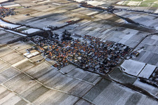 View of a winegrowing village in winter between snow-covered vineyards from the northeast in Walsheim in the state Rhineland-Palatinate, Germany