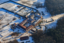 Horse boarding at Liebfrauenberg Monastery in winter with snow in Bad Bergzabern in the state Rhineland-Palatinate, Germany from above