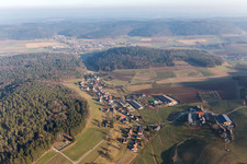 Aerial photograpy of Village - view on the edge of agricultural fields and farmland in Kocherbach in the state Hesse, Germany