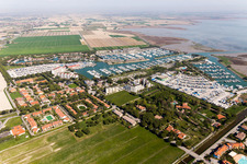 Aerial view of Pleasure boat marina with docks and moorings on the shore area of Marina Punta Gabbiani Aprilia Marittima in the district Aprilia Marittima in Bevazzana in Friuli-Venezia Giulia, Italy