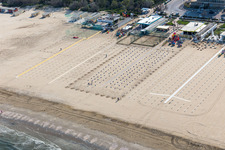 Beach landscape along the adriatic sea with rows of empty beach chairs in the district Pinarella in Cervia in Emilia-Romagna, Italy