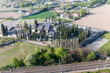 Grave rows on the grounds of the cemetery with cypress trees in San Michele Al Tagliamento in Venetien, Italy