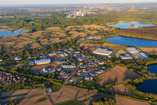 Industrial area Industriestraße from the southwest with Heidelberg Materials Mineralik, OFTEC Oberflächentechnik GmbH & Co. KG and Faurecia Innenraum Systeme GmbH in Hagenbach in the state Rhineland-Palatinate, Germany