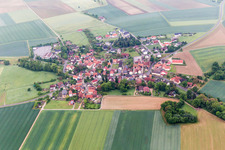Village - view on the edge of agricultural fields and farmland in Bischwind in the state Bavaria, Germany
