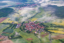 Aerial view of Village under clouds in the district Wustviel in Rauhenebrach in the state Bavaria, Germany