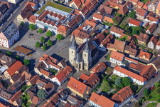 Parish Church of St. Kilian on the market square with market fountain in Haßfurt in the state Bavaria, Germany