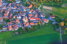 Village edge with St. Vitus Church from the north in the district Kaisten in Wasserlosen in the state Bavaria, Germany