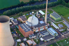 Cooling towers and reactor dome of the nuclear power plant Grafenrheinfeld of Preussenelektra GmbH at sunset in Grafenrheinfeld in the state Bavaria, Germany