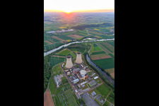 Cooling towers and reactor dome of the nuclear power plant Grafenrheinfeld of Preussenelektra GmbH at sunset in Grafenrheinfeld in the state Bavaria, Germany from above