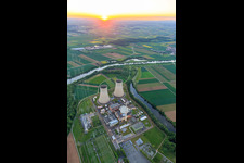 Cooling towers and reactor dome of the nuclear power plant Grafenrheinfeld of Preussenelektra GmbH at sunset in Grafenrheinfeld in the state Bavaria, Germany out of the air