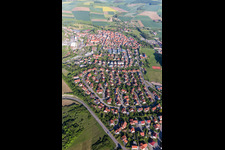 Aerial photograpy of Village - view on the edge of agricultural fields and farmland in Stadtlauringen in the state Bavaria, Germany