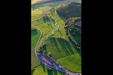 Aerial view of Meandering, serpentine curve of a stream - river Baunach in the district Frickendorf in Ebern in the state Bavaria, Germany