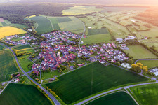 Village - view on the edge of agricultural fields and farmland in the district Loeffelsterz in Schonungen in the state Bavaria, Germany