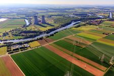 Cooling towers and high-voltage lines to the nuclear power plant Grafenrheinfeld of Preussenelektra GmbH on the Main river bank from the west in Grafenrheinfeld in the state Bavaria, Germany