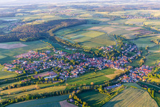 Aerial view of Village - view on the edge of agricultural fields and farmland in Schoenbrunn im Steigerwald in the state Bavaria, Germany