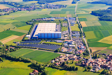 Industrial estate Am Rödertor behind an open-space PV plant with DLZ Donnersdorf central warehouse and Kaufland Logistik VZ GmbH & Co. KG and Baumann Recycling GmbH in Donnersdorf in the state Bavaria, Germany