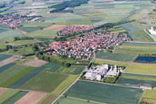 Aerial view of Village - view on the edge of agricultural fields and farmland in Sulzheim in the state Bavaria, Germany
