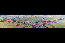 Aerial view of Panoramic perspective Village - view on the edge of agricultural fields and farmland in Steinseltz in Grand Est, France