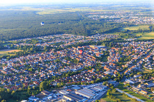 Two hot air balloons over the village in Dudenhofen in the state Rhineland-Palatinate, Germany