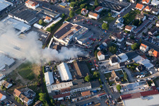 Aerial photograpy of Smoke and flames during the fire fighting to fire of a storage all for antiqities in the Werkstrasse in Speyer in the state Rhineland-Palatinate, Germany