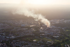 Smoke and flames during the fire fighting to fire of a storage all for antiqities in the Werkstrasse in Speyer in the state Rhineland-Palatinate, Germany from the drone perspective